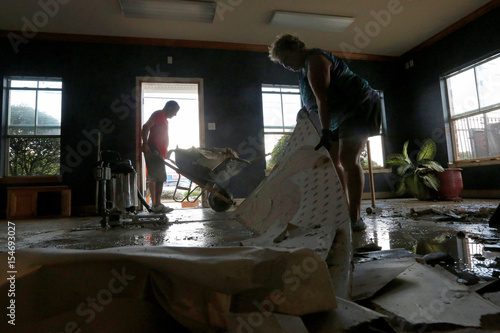 sharon bogan and her son kevin remove drywall from their flooded