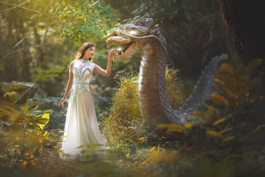 Fototapete - Fairy tale of a girl with a dragon in the forest