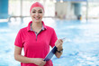 © FS-Stock - Fit female swimming trainer with tablet at the pool