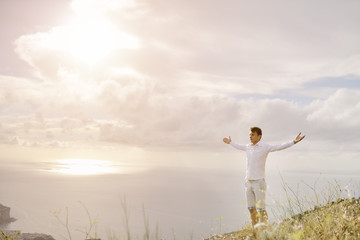 Wall Mural - Young man with arms wide open - relax freedom success concept