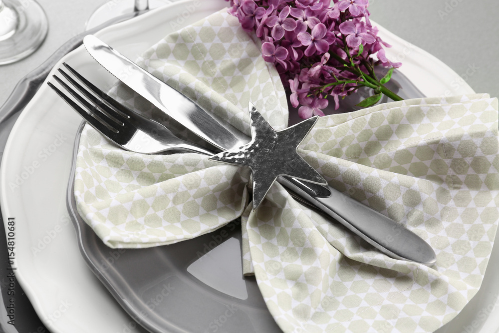 Beautiful festive table setting with lilac flower decor, closeup