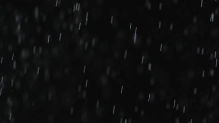 Wall Mural - rain or snow fall concept. falling raindrops or snow against a black background. close-up shot