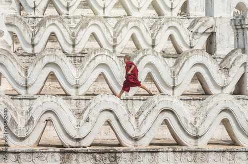 The young monk are running and jumping on the Mya Thein Tan Pagoda at bagan, man Poster