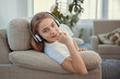 © svetabezu - Beautiful teenage girl with smartphone and headphones listening music.