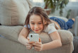 © svetabezu - Beautiful little girl with smartphone. Leisure, children, technology and people concept