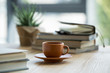 © LIGHTFIELD STUDIOS - Close-up view of cup of coffee and notebooks on wooden table top