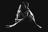 Beautiful nude couple sitting on the floor.