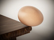 Egg standing at the edge of the table. 3D illustration