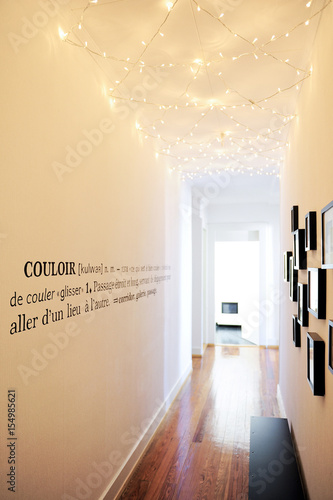 Long White Corridor Illuminated By A Garland On The Ceiling And
