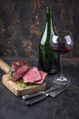 Barbecue Wagyu Point Steak with a Glass of Red Wine as close-up on an old metal sheet