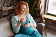© Viacheslav Yakobchuk - Redhead prospective mother beaming with joy