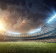 soccer stadium with illumination and green grass on sunset