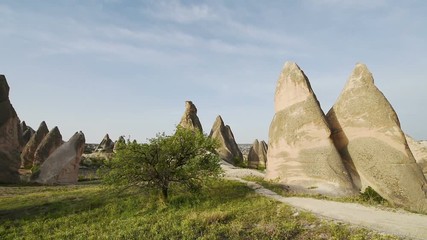 Wall Mural - Amazing view of Turkish fortress Uchisar in the Cappadocia, Turkey. Cappadocia with its valley, ravine, hills, located between the volcanic mountains in Goreme National Park.