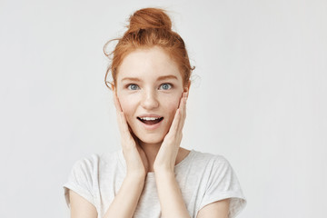 Wall Mural - Portrait of surprised happy girl with foxy hair and freckles.