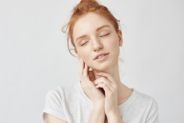 Poster - Portrait of tender girl with foxy hair and closed eyes smiling.