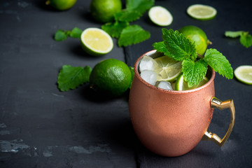 Cold Moscow Mule cocktail in copper mug on the rustic background. Shallow depth of field.