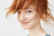 © Cookie Studio - Close up portrait of funny redhead girl smiling looking at camera.