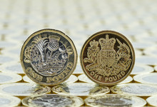 Comparison Of Old And New British One Pound Coins.