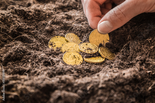 Woman S Hand Holding Golden Euro Coins On The Ground - 