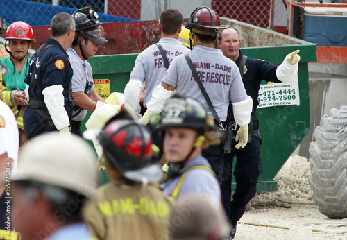Rescue Workers Carry A Victim From The Scene Of A Parking Garage