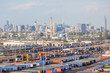 © mrcmos - Cargo shipping containers with New York City view in background.