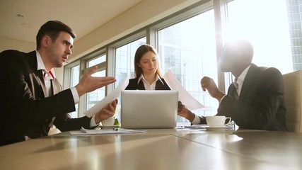 Wall Mural - Three multicultural business partners reach agreement at meeting in office, shaking hands over the desk, happy to establish partnership, confident entrepreneurs handshaking making profitable deal