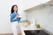 © Saksoni - Wellness concept. Beautiful young woman making breakfast and smiling. Healthy eating. Dieting concept.