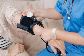 Wall Mural - Precise trained medical worker employing tonometer