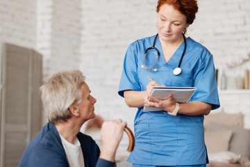 Wall Mural - Neat mindful doctor hearing out her patient