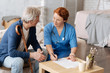 © zinkevych - Private nurse and elderly man discussing the contract