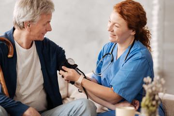 Wall Mural - Diligent trained doctor putting on a blood pressure sensor