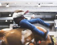 Cowbow Participant Riding A Crazy Mechanical Bull