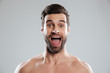 © Drobot Dean - Excited bearded man with naked shoulders and open mouth