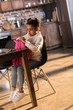 © LIGHTFIELD STUDIOS - Cute little girl holding backpack while sitting at table with felt tip pens, doing homework concept
