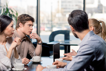 Wall Mural - business team on meeting discussing project with laptop in cafe, business lunch concept