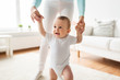 © Syda Productions - happy baby learning to walk with mother help