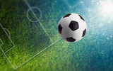 Fototapeta Sport - Soccer ball on green soccer field