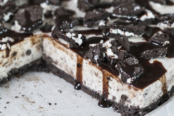 Homemade chocolate cookies cheesecake close up.