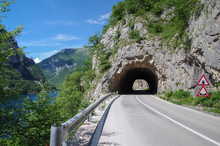 Road Tunnel In The Rock. Highway Tunnel Cutting Through A Mountain. Montenegro, Lake Piva
