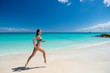 © be free - Young woman running at the tropical beach