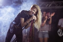 Cheerful Female Singer Performing During Music Festival