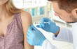 © Africa Studio - Vaccination concept. Male doctor vaccinating young woman
