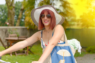 Wall Mural - Beautiful girl leaving to the beach in bicycle