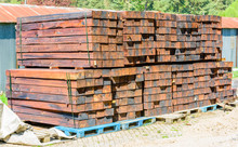 Stacked New And Unused Railroad Ties Or Sleepers On Pallets Outdoors.
