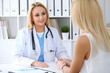 © rogerphoto - Doctor reassuring her female patient. Medicine, help and health care concept
