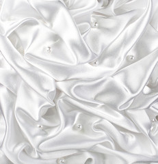 background of white brocade and silvet satin with pearl and waves tissue occupying the entire surface of the background