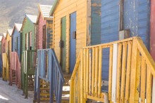 Close Up Of Multi Colored Wooden Huts On Sand