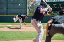 Mens' Baseball Pitcher Throwing The Curveball To The Batter.  