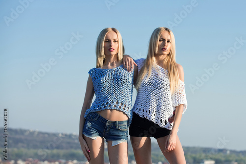 Download Twin Sisters Sexy Girls Posing On Blue Sky Buy This Stock Desktop Wallpaper Get Wallpaper Twin Sisters Sexy Girls Posing On Blue Sky Buy This Stock For Android