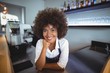 © WavebreakMediaMicro - Portrait of confident waitress standing at counter